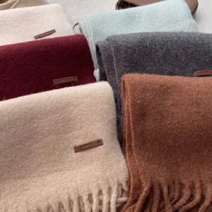 Thick wool scarf in multiple colors with tassels and leather labels for winter warmth