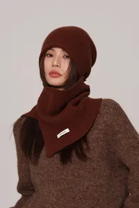 Detail of premium knitted texture on 100% wool beanie and matching scarf set in brown