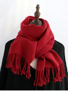 Detailed texture of thick red wool scarf with classic fringe on a mannequin