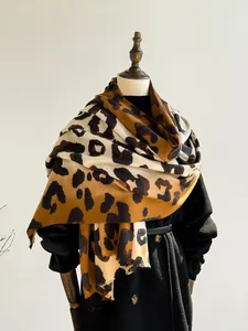 Close-up of leopard print cashmere feel scarf with soft fringe and thick texture