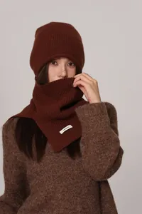 Detail of 100% pure wool brown knit beanie and scarf set with ribbed texture