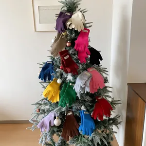 Chic winter knitted touchscreen gloves in multiple colors on a festive Christmas tree