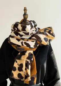 Detail of leopard print thick scarf with fringed edges on a display stand