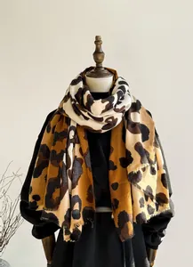 Detail of leopard print cashmere feel scarf showing soft texture and fringed edges