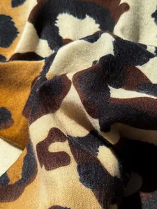 Close-up of soft leopard print scarf showing thick cashmere texture and brown patterns
