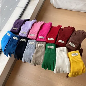Women's warm knitted touchscreen gloves shown in various colors with ribbed cuffs
