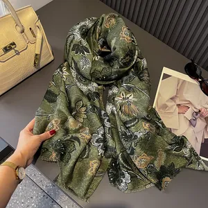 Detail of floral printed green shawl with premium tassel edges and soft cotton-linen texture