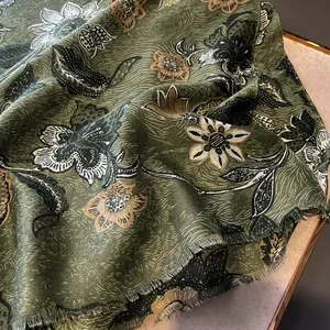 Close-up of cotton-linen scarf featuring floral peony patterns and fine fringe edges