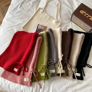 Flat lay of knit balaclavas with faux fur trim and adjustable drawstrings in multiple colors