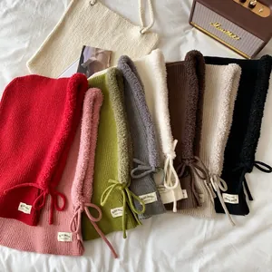 Overhead view of various colored knitted balaclava hats with soft fleece lining