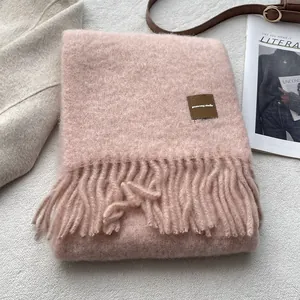 Pink mohair blend scarf with long tassels and leather label for winter warmth