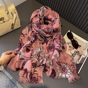 Detail of floral linen-feel scarf in dusty pink with soft fringes and fashion accessories