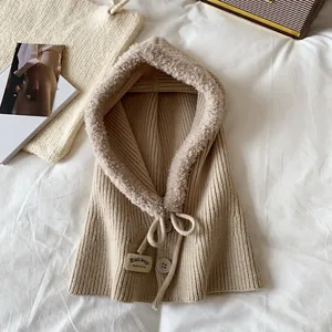 Detail of beige knitted balaclava with warm lamb wool lining, buttons and drawstring cord