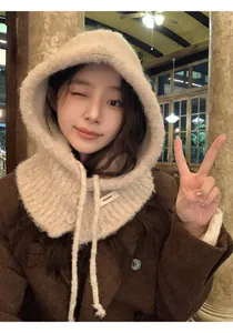 Detail of beige knitted balaclava with drawstring and side button for winter warmth