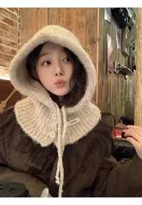 Close-up of beige knit balaclava hood with faux fur trim and dual button closure