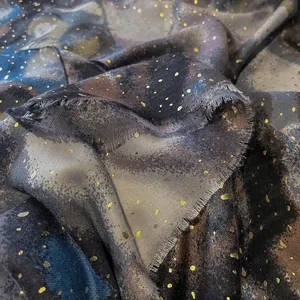 Linen feel scarf with gold foil dots and marble print featuring soft fringe edges