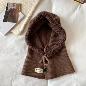 Detail of knit brown balaclava with warm fleece lining and decorative buttons