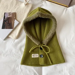 Close-up of green knit balaclava showing warm fleece lining and button details