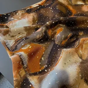 Detail of artistic cotton linen scarf with gold foil accents and abstract colorful dye