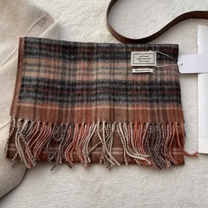 Detailed view of 100% Australian wool scarf texture with vintage plaid and tassel hem