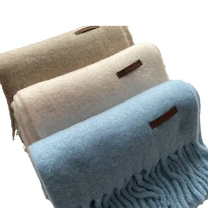 Three premium wool-blend scarves in blue, khaki, and beige with leather tags and tassels