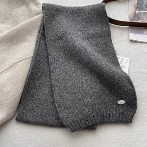 Mid-grey soft wool blend knitted scarf with rib knit edges and a silver metal logo plaque