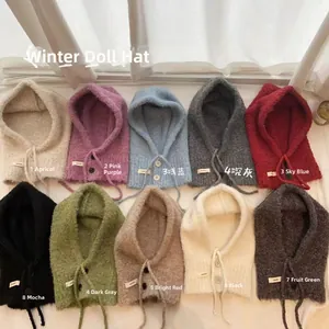 Flat lay of knit balaclava hoods in ten vibrant colors with soft mohair texture