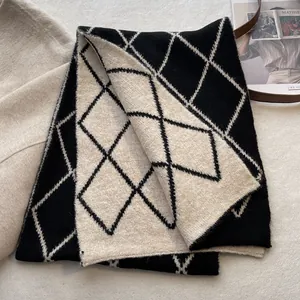 Detailed view of the argyle pattern on a thick double-sided wool knit winter scarf