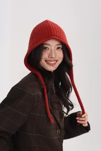 Detail of red wool knit ear-protection beanie with vertical ribbed texture and retro style