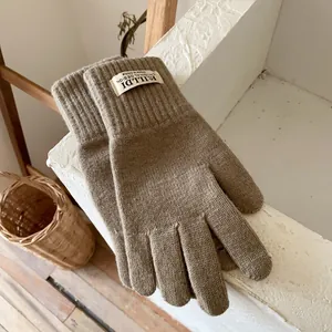 Close-up of thick knitted winter gloves with ribbed cuffs and fuzzy wool texture