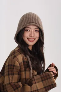 Close-up of brown 100% wool knit hood and vintage plaid wool coat texture and detail
