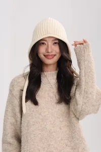 Close-up of warm beige wool knit hat featuring ribbed texture and winter cozy style