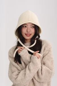 Detail of off-white wool knit bucket hat with vertical ribbing and soft chin straps