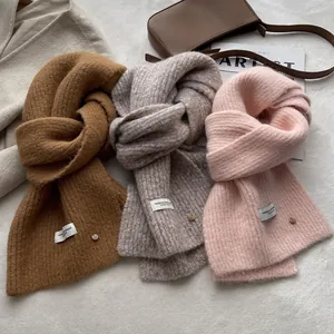 Soft wool blend knitted scarf in camel and pink with chic decorative buttons and tags