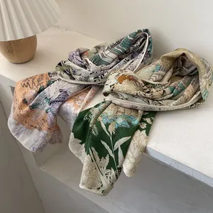 Elegant tropical palm leaf print silk scarves in warm orange and vibrant green hues