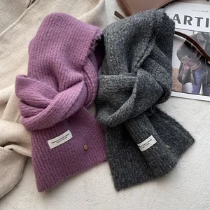 Detailed knit texture of wool scarves in purple and dark grey with fabric labels