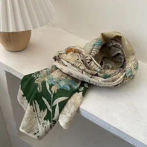 Elegant vintage silk-blend scarf with floral and architectural prints on a white table