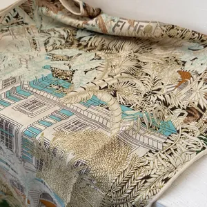 Macro detail of silk wool scarf featuring tropical forest motifs and classical architecture