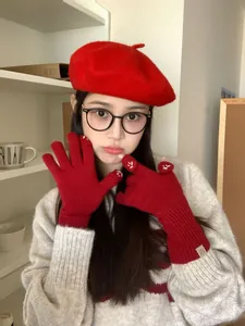 Cute red knitted winter gloves with smiling face embroidery and matching beret set