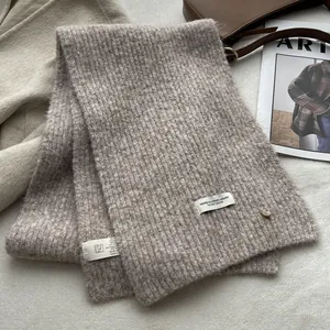 Detailed texture of gray-brown wool blend knit scarf with classic ribbed pattern