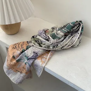 Close-up of floral silk scarf with rolled edges and elegant botanical prints