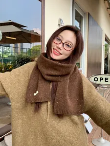 Close-up of deep brown wool knit scarf with colorful tweed texture and vintage style