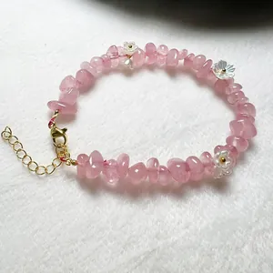 Natural pink strawberry crystal beaded bracelet with white floral accents and gold clasp