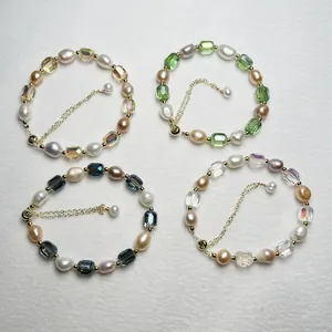 Detail view of four baroque pearl bracelets with faceted emerald-cut beads and gold chains