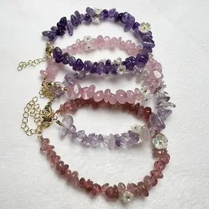 Detailed view of natural gemstone bead bracelets with floral accents and gold clasps