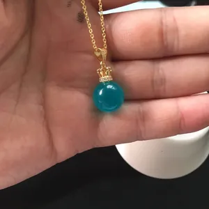 Detail of Amazonite pendant with golden crown bail and fine metal necklace chain