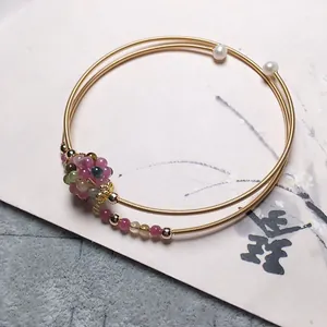 Detail view of 14K gold filled multi-strand bracelet with tourmaline beads and pearls