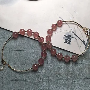 Pink strawberry quartz beaded bracelet with gold lobster clasp and adjustable chain