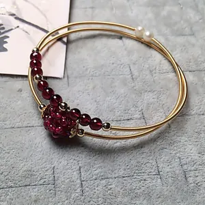 Close-up of double-layer garnet bead bracelet with 14K gold-filled wire and pearl accents