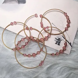 Detail of strawberry quartz beaded bracelet with 14K gold filled wire wrapping